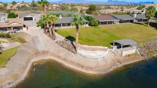 an aerial view of residential houses with outdoor space and swimming pool