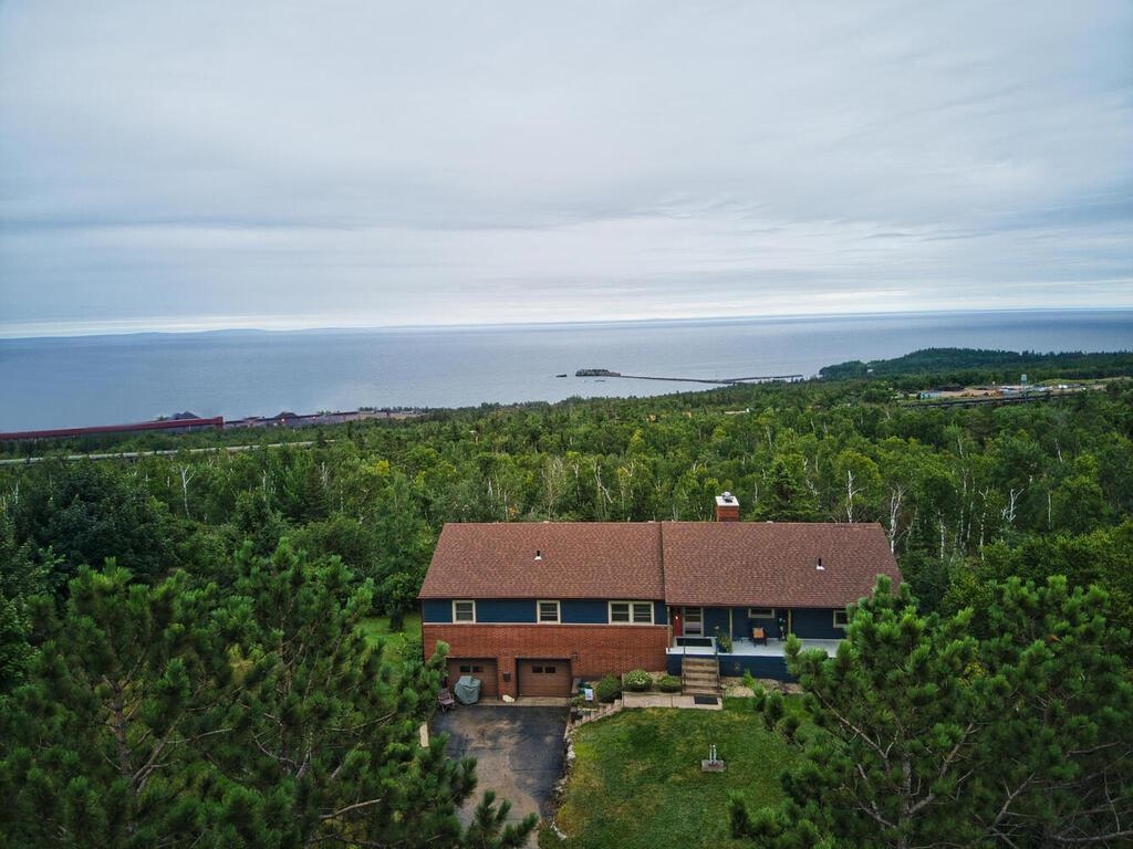 7 Kent Lane Silver Bay, MN 55614 - Photo 2 of 32 View of property location featuring a heavily wooded area and a nearby body of water