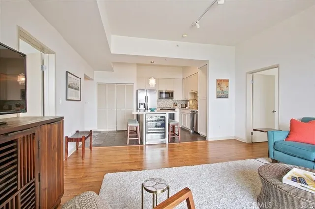 a living room with furniture wooden floor and a flat screen tv