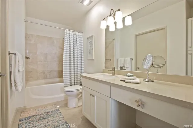 a bathroom with a double vanity sink toilet and shower