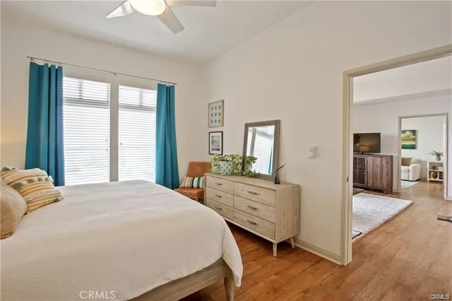 a spacious bedroom with a bed and a dresser