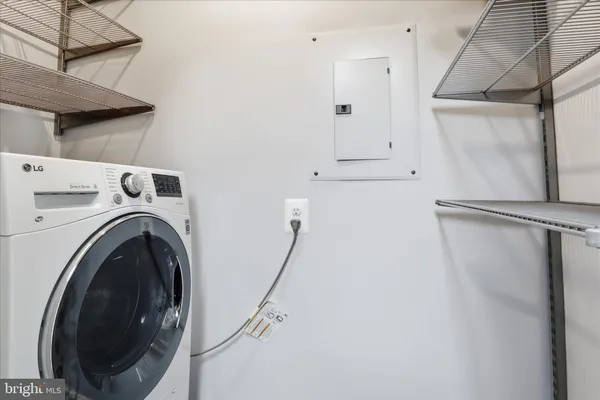 a view of a storage & utility room with dryer and washer