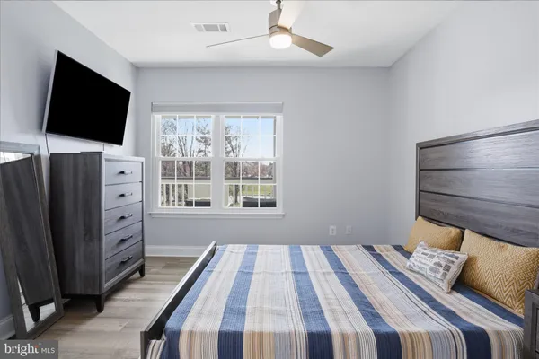 a bedroom with a bed and flat screen tv