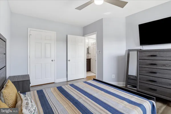a bedroom with bed and a flat screen tv
