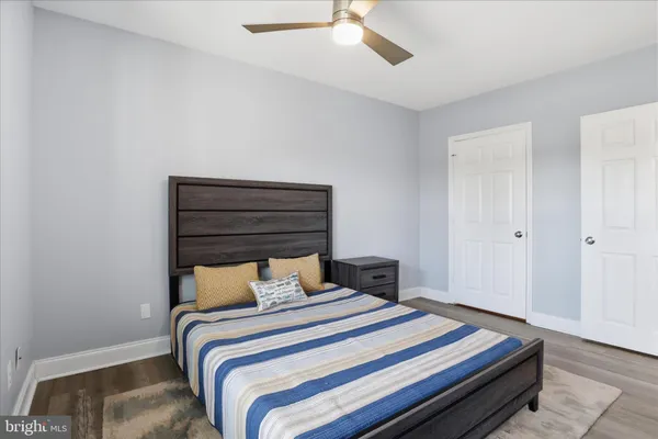 a bedroom with a bed and a ceiling fan