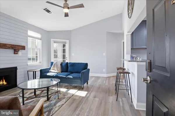 a living room with furniture and a fireplace