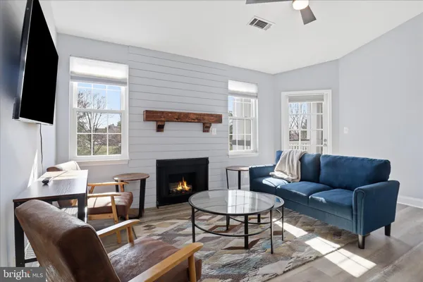 a living room with furniture flat screen tv and a fireplace