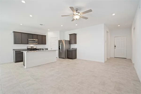a view of a kitchen with a sink cabinets and stainless steel appliances