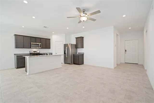 a view of a kitchen with a sink cabinets and stainless steel appliances
