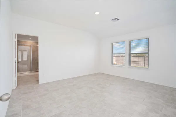 an empty room with windows and closet