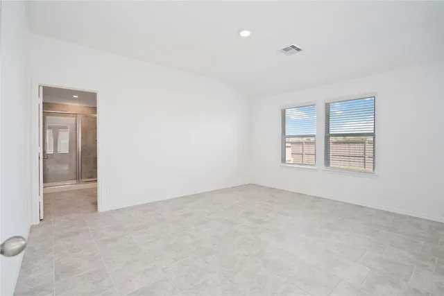 an empty room with windows and closet
