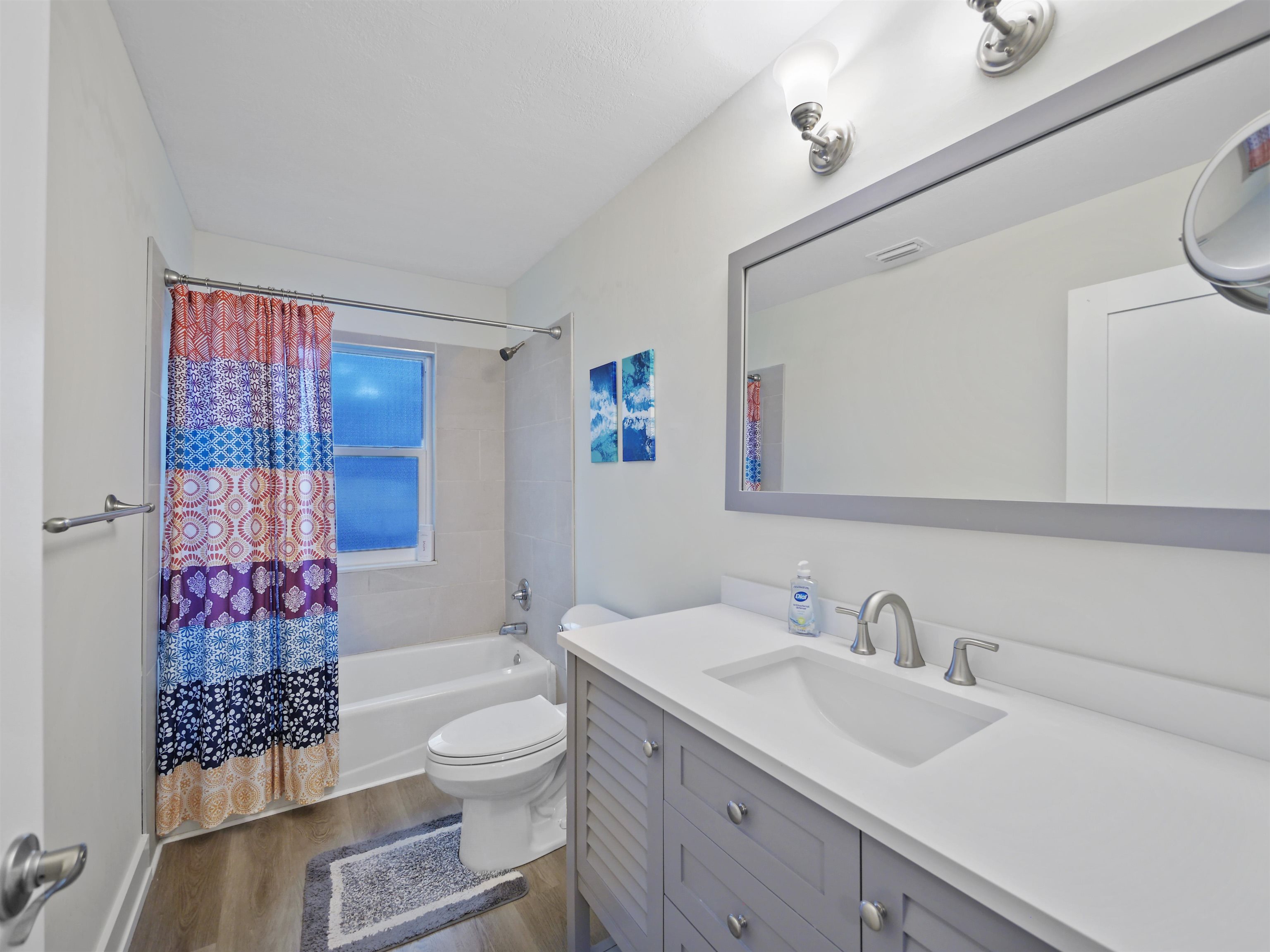 208 A Street St. Augustine, FL 32080 - Photo 3 of 10 a bathroom with a granite countertop sink mirror vanity and toilet