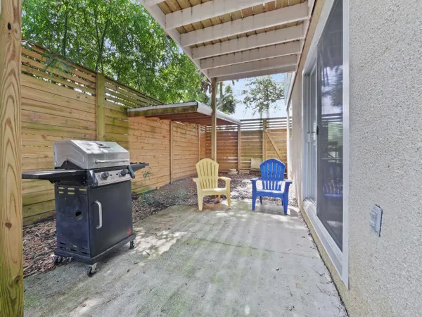a view of a patio with table and chairs next to a yard