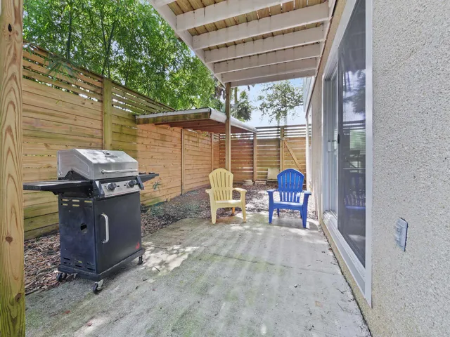 a view of a patio with table and chairs next to a yard