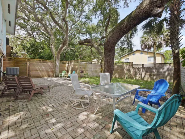 a view of a patio with a table chairs and a fire pit