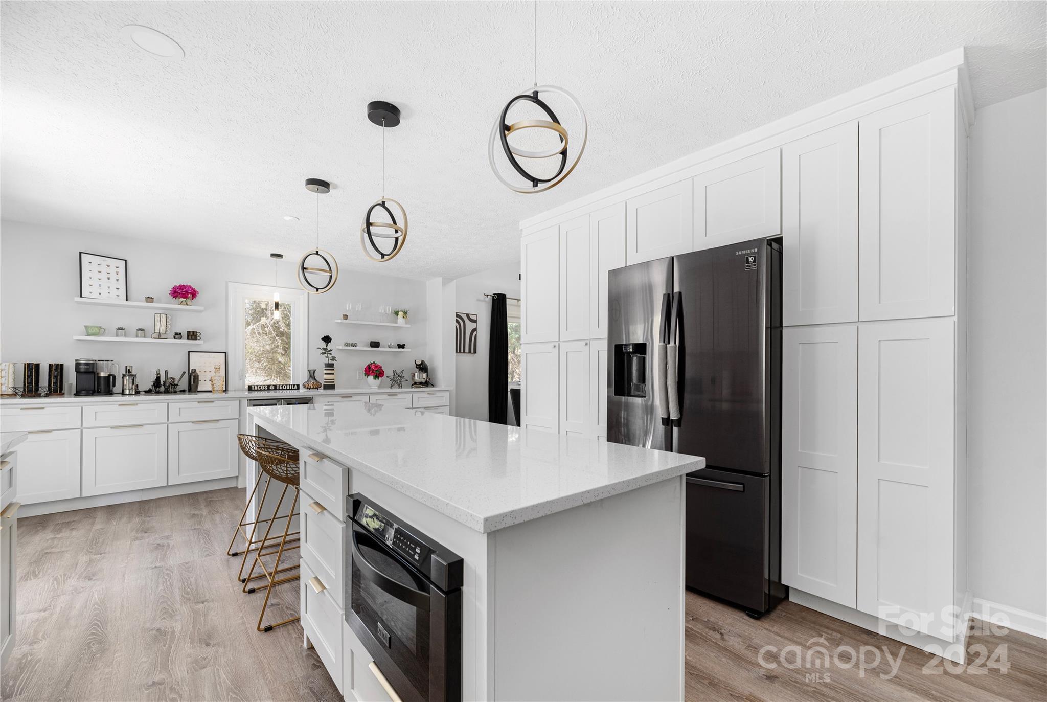 262 Spring Run Road Mooresville, NC 28117 - Photo 13 of 48 a kitchen with a refrigerator and countertop white cabinets