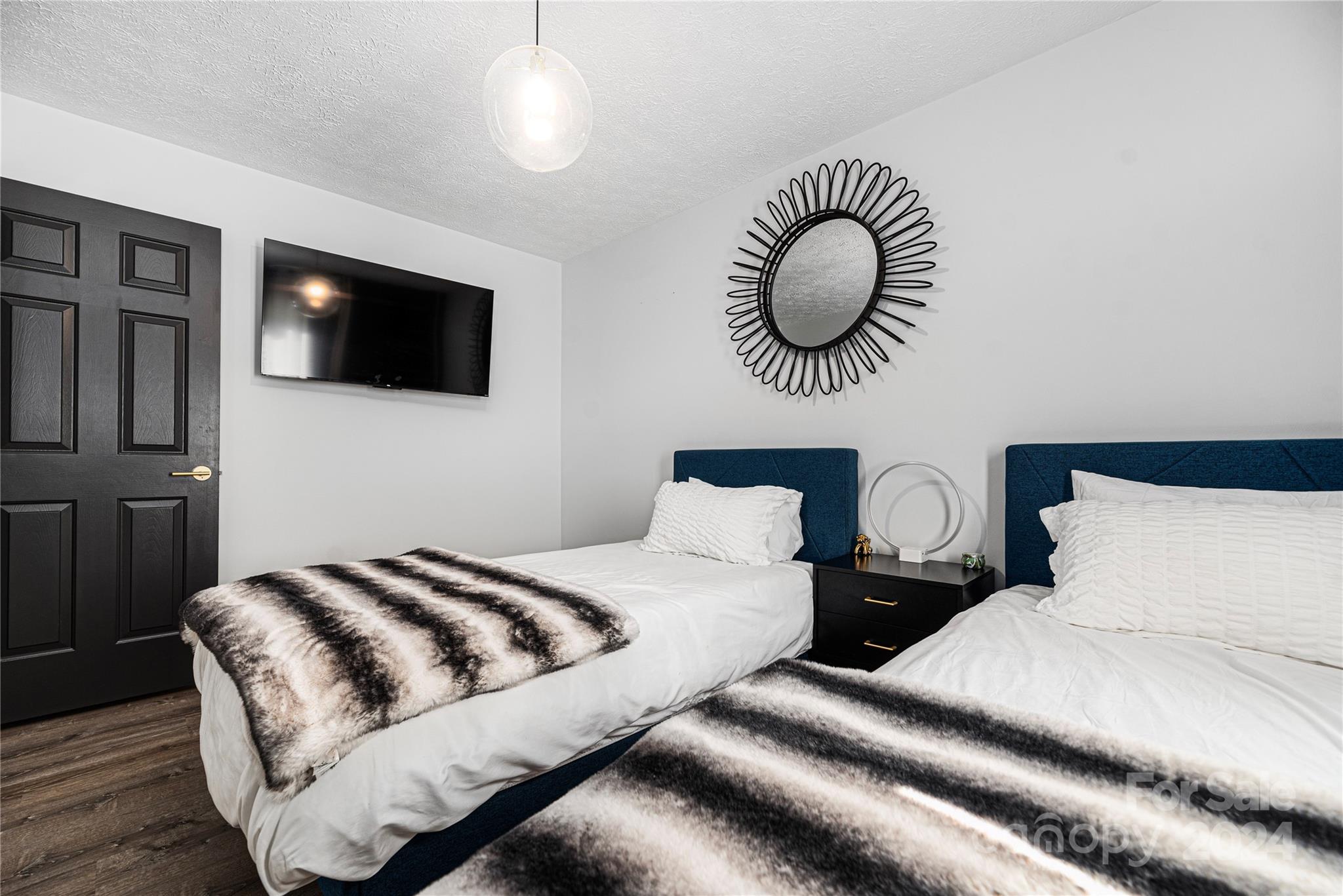 262 Spring Run Road Mooresville, NC 28117 - Photo 19 of 48 a bedroom with a large bed and a flat screen tv