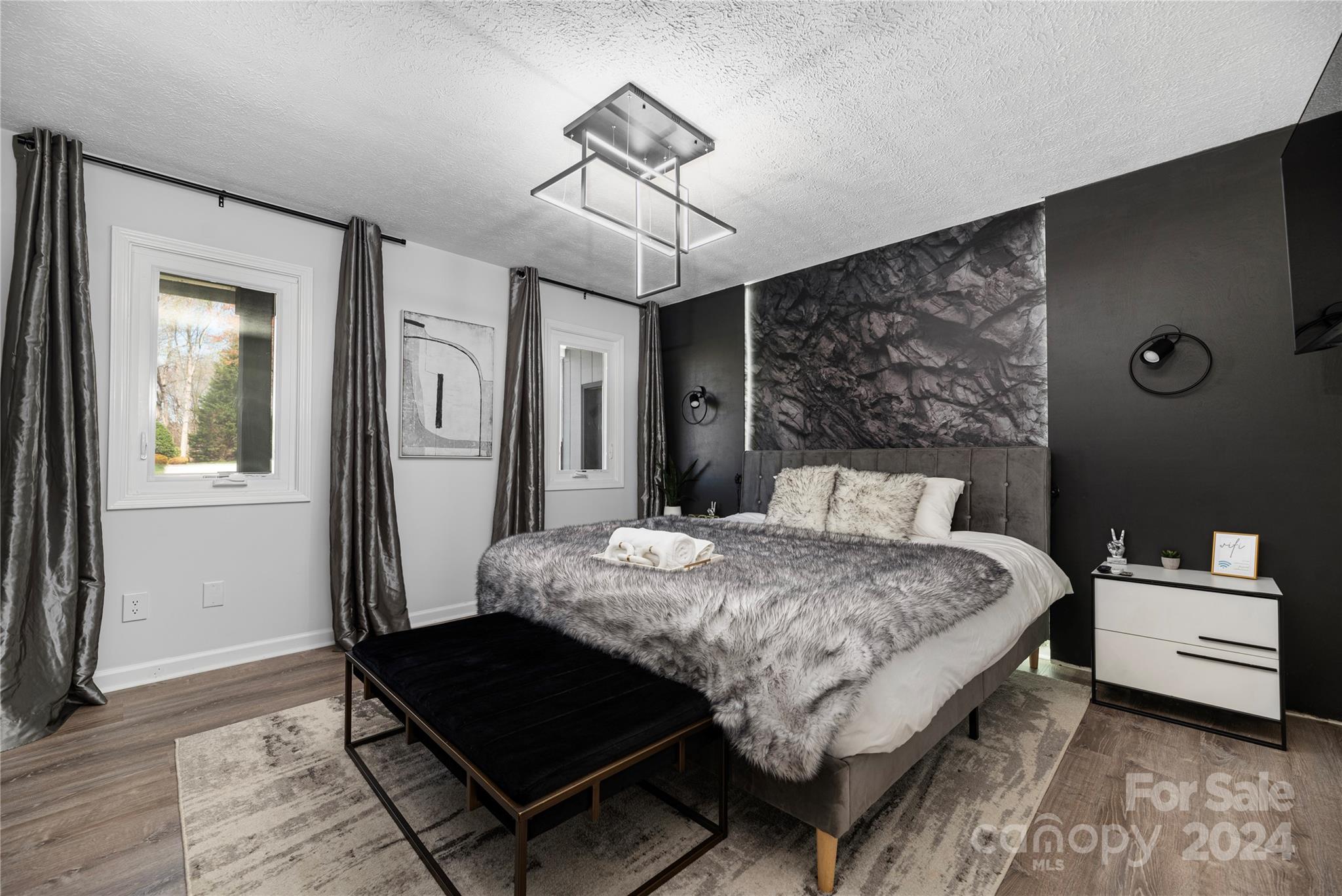 262 Spring Run Road Mooresville, NC 28117 - Photo 20 of 48 a bedroom with a bed and a chandelier