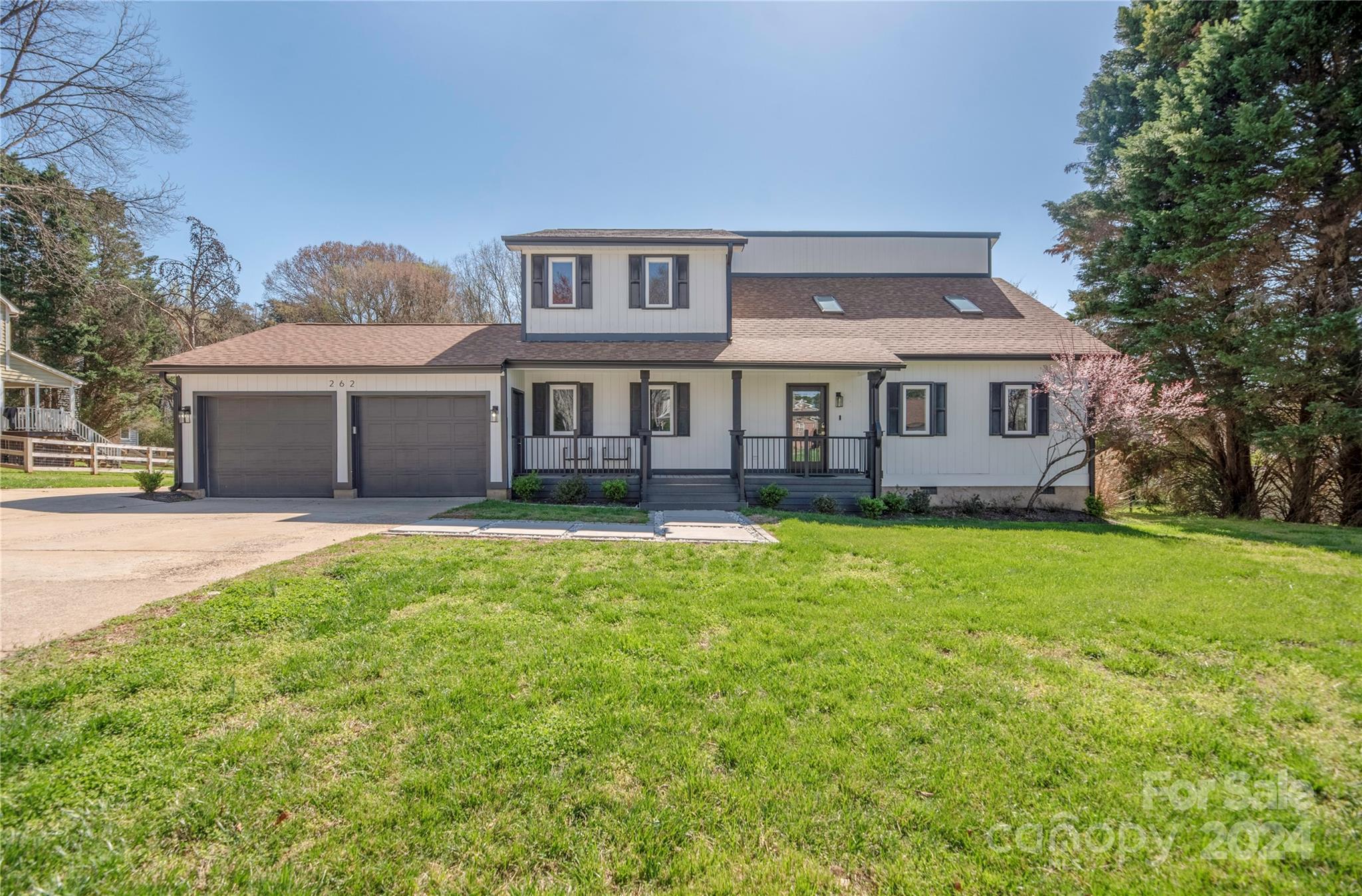 262 Spring Run Road Mooresville, NC 28117 - Photo 2 of 48 a front view of a house with a garden and lake view