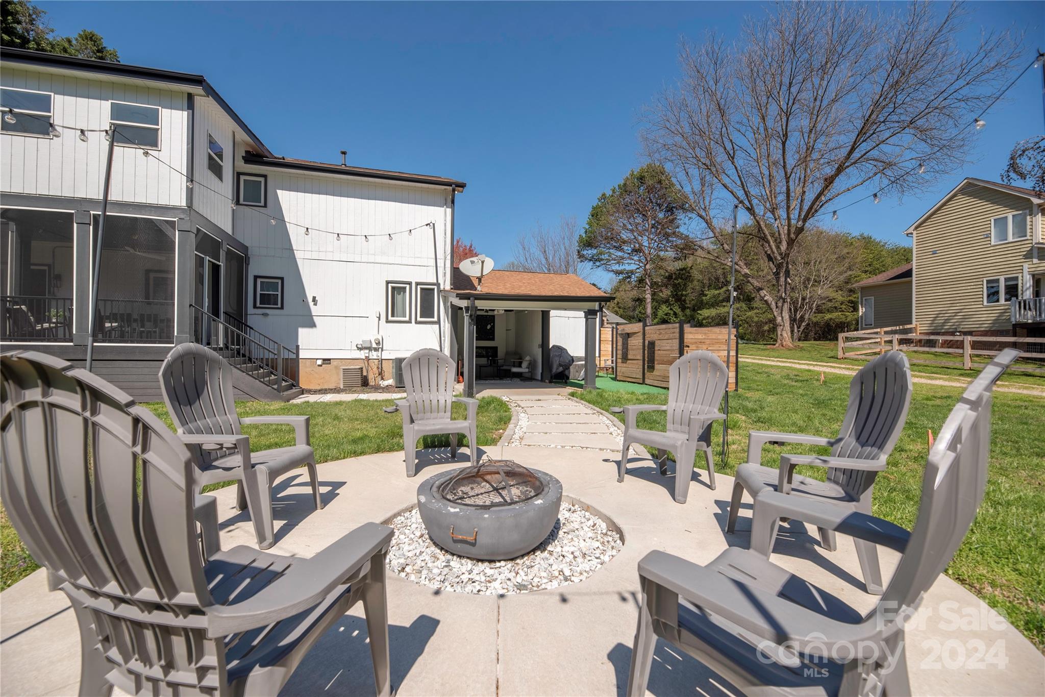 262 Spring Run Road Mooresville, NC 28117 - Photo 43 of 48 a view of a patio with table and chairs potted plants and a large tree