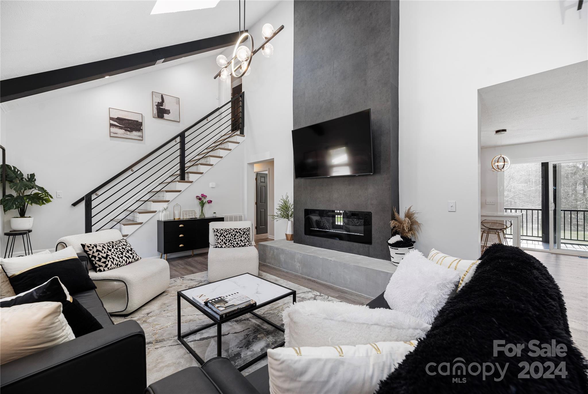 262 Spring Run Road Mooresville, NC 28117 - Photo 10 of 48 a living room with furniture a flat screen tv and a fireplace