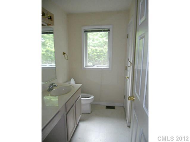 301 Commodore Loop Mooresville, NC 28117 - Photo 11 of 16 a bathroom with a granite countertop sink a toilet and shower