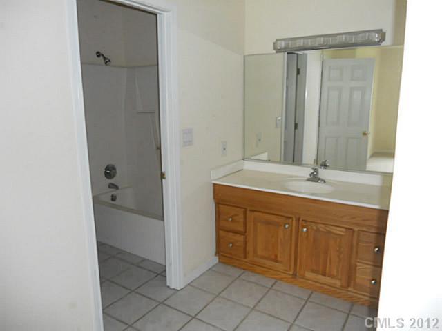 301 Commodore Loop Mooresville, NC 28117 - Photo 13 of 16 a bathroom with a sink and a mirror
