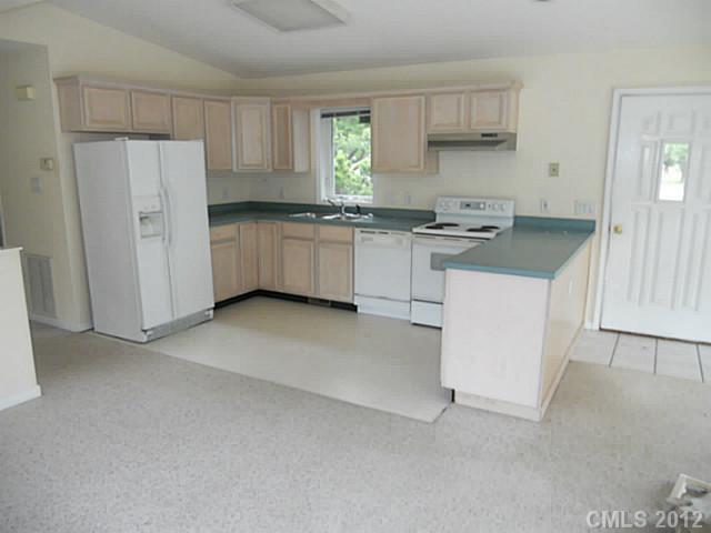 301 Commodore Loop Mooresville, NC 28117 - Photo 6 of 16 a kitchen with white cabinets and white appliances