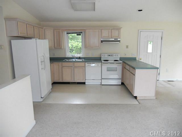 301 Commodore Loop Mooresville, NC 28117 - Photo 7 of 16 a kitchen with white cabinets and white appliances