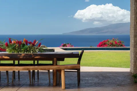 a table with flowers and a chair