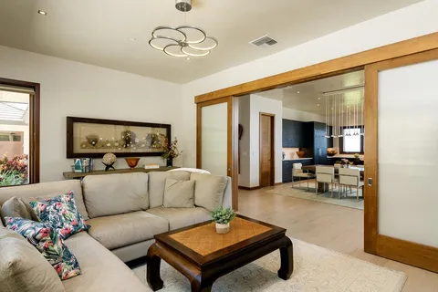 a large bedroom with a bed and wooden floor
