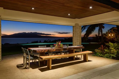 a view of a dining room with a table and chairs