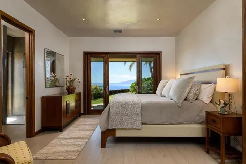 a bedroom with a large bed and a balcony view