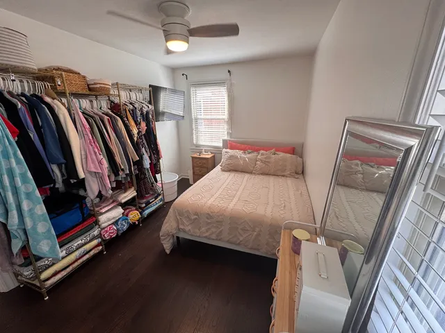 a bedroom with a bed and a mirror