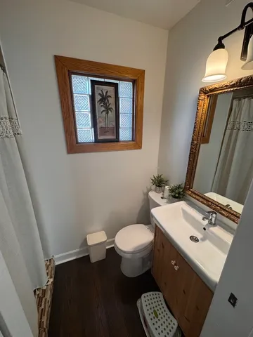 a bathroom with a toilet sink and mirror