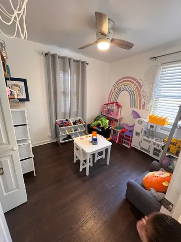 a living room with furniture and a baby crib