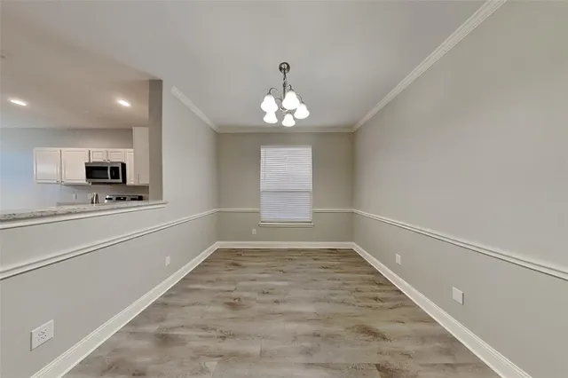 a view of a hallway with a sink and a window