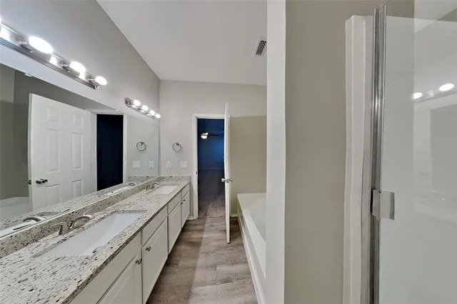 a bathroom with a double vanity sink and a mirror