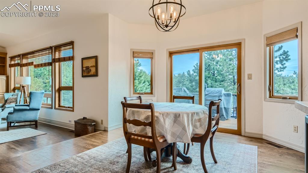 65 Pontiac Loop Monument, CO 80132 - Photo 19 of 49 a view of a dining room with furniture window and wooden floor