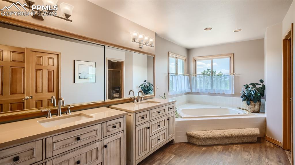 65 Pontiac Loop Monument, CO 80132 - Photo 29 of 49 a spacious bathroom with double vanity a mirror a bathtub and double