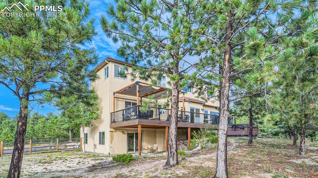 65 Pontiac Loop Monument, CO 80132 - Photo 43 of 49 a front view of a house with a garden and trees