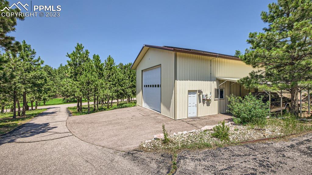 65 Pontiac Loop Monument, CO 80132 - Photo 48 of 49 a front view of a house with a yard and garage