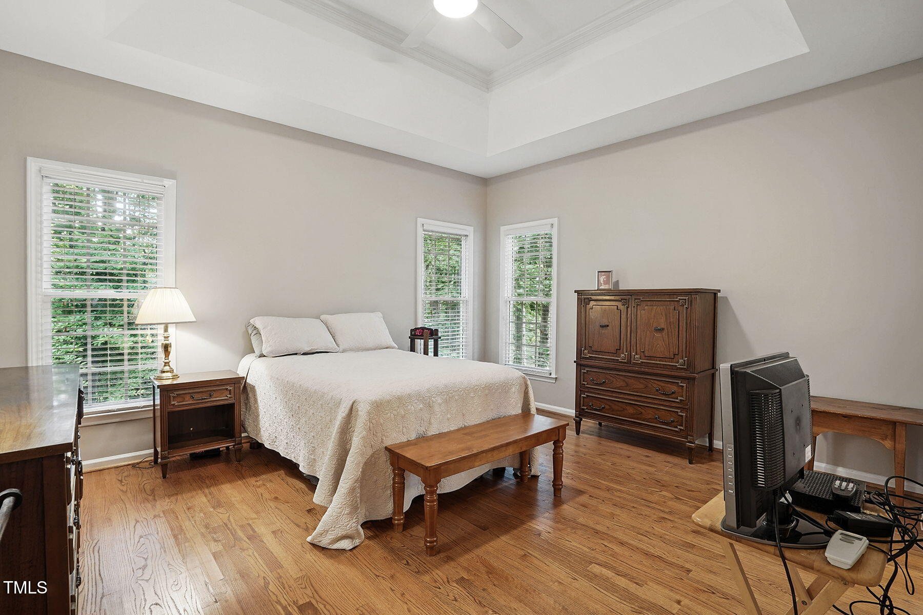 2425 Lemuel Drive Raleigh, NC 27615 - Photo 17 of 36 Spacious primary bedroom with hardwood floors, tray ceiling, and attached primary bath is situated at the back of the house.