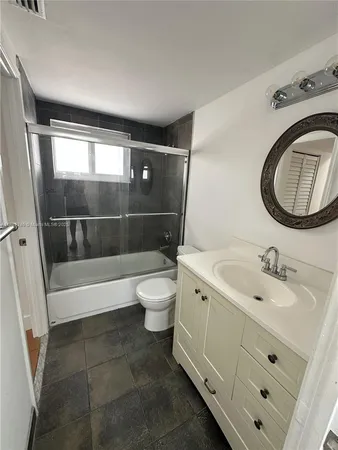 a bathroom with a toilet a sink and a mirror