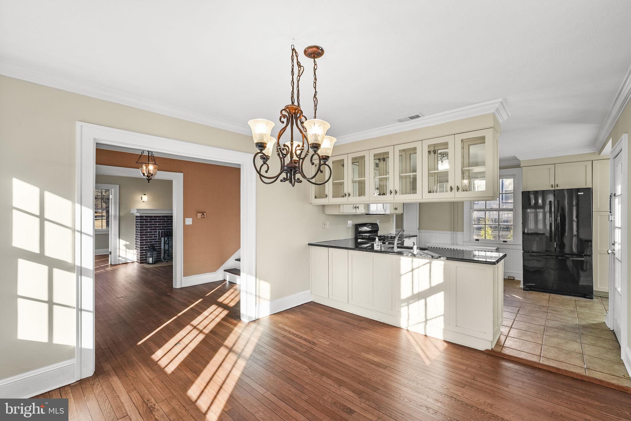 2046 Pennington Road Ewing, NJ 08618 - Photo 11 of 37 a kitchen with stainless steel appliances granite countertop a stove oven and a wooden floors