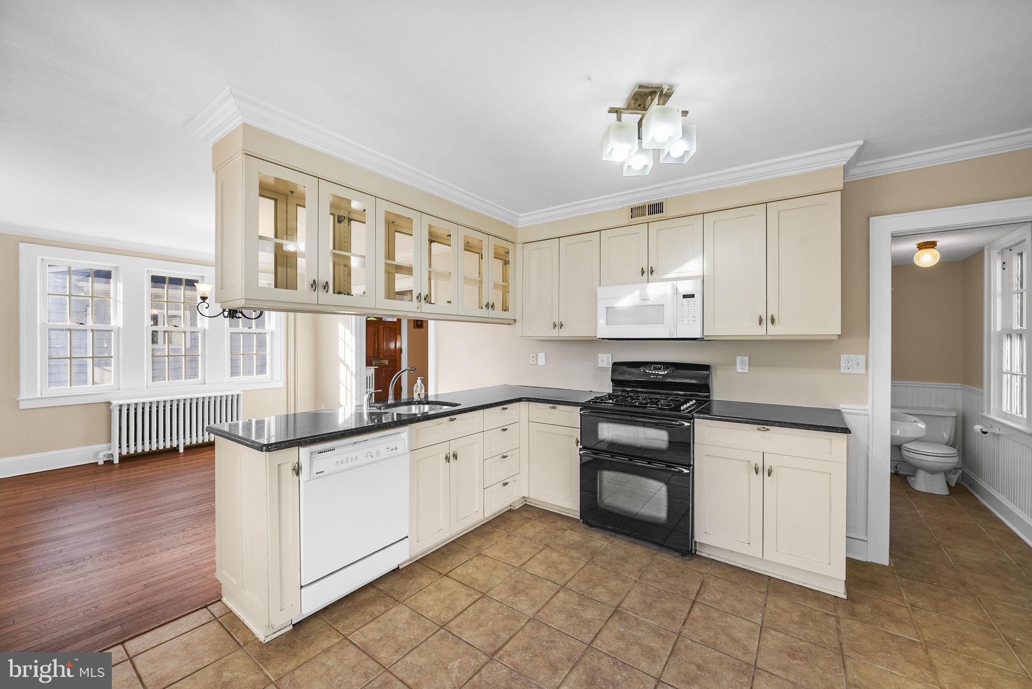2046 Pennington Road Ewing, NJ 08618 - Photo 13 of 37 a kitchen with granite countertop a sink and cabinets
