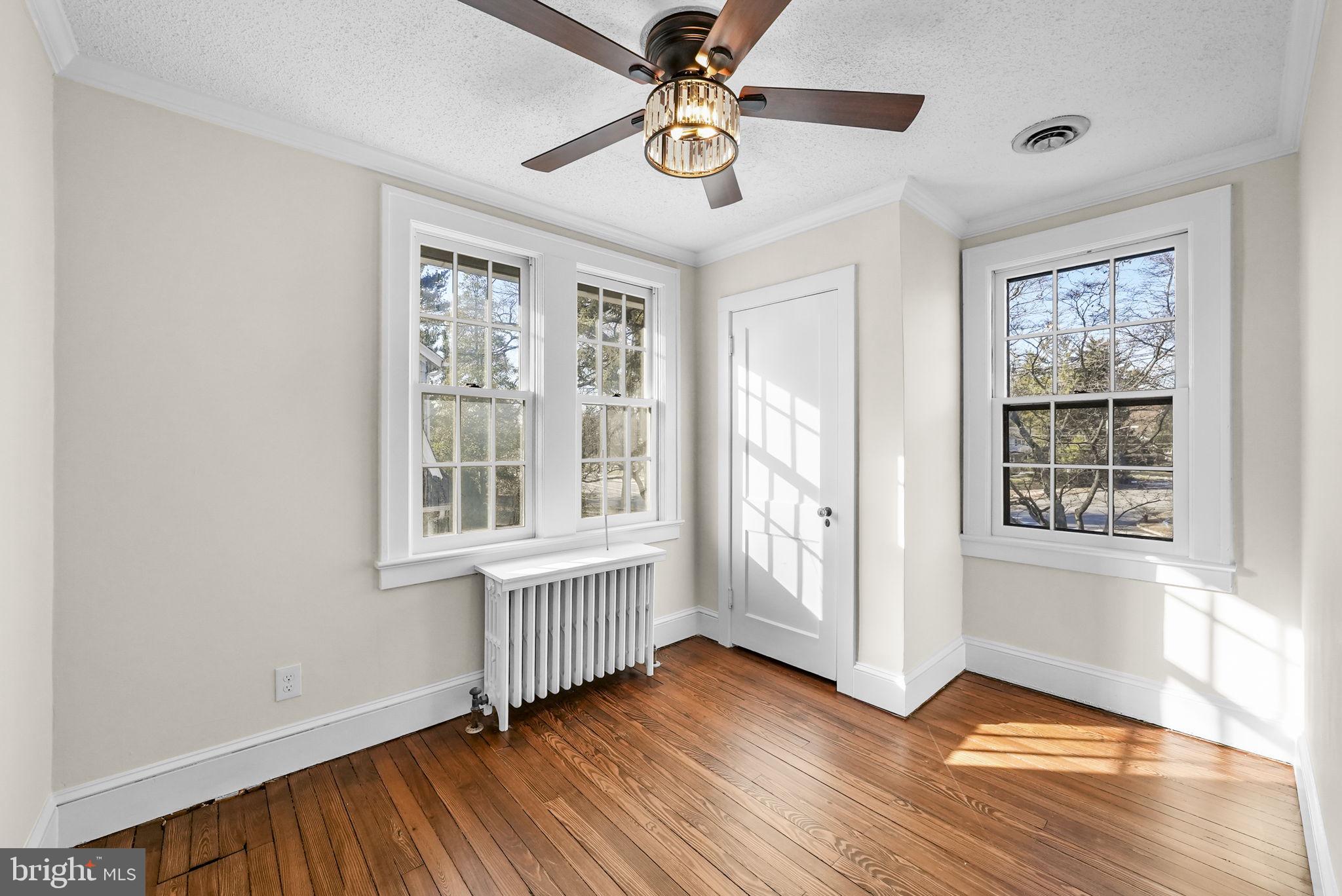 2046 Pennington Road Ewing, NJ 08618 - Photo 30 of 37 an empty room with wooden floor chandelier fan and windows