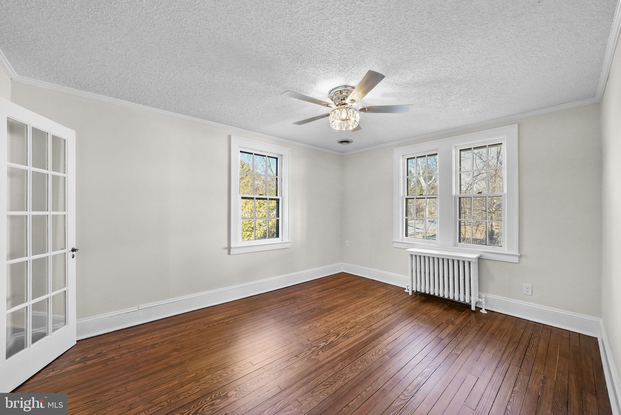 2046 Pennington Road Ewing, NJ 08618 - Photo 32 of 37 a view of an empty room with a window and wooden floor