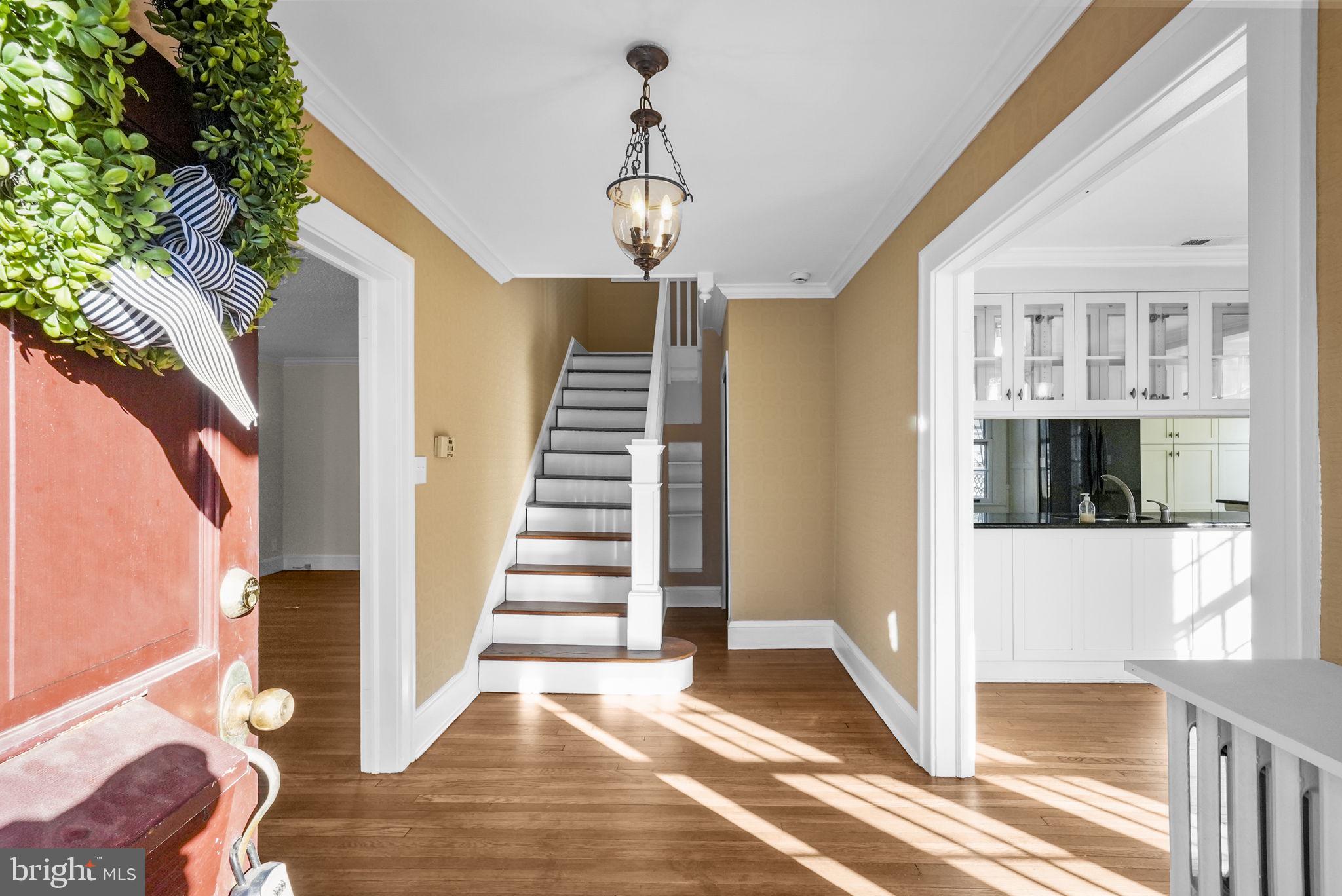2046 Pennington Road Ewing, NJ 08618 - Photo 34 of 37 a view of a hallway with wooden floor and staircase