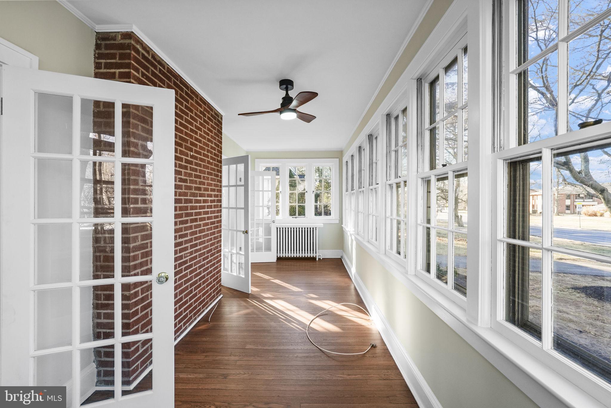 2046 Pennington Road Ewing, NJ 08618 - Photo 5 of 37 a view of an entryway with wooden floor and windows